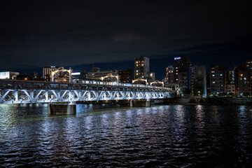 Fototapeta na wymiar train bridge over the sumida river in tokyo japan at night