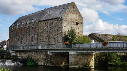 The ancient Gueguen mill in Malestroit, France, on the river Oust, centuries old, built of stone,...