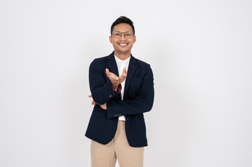 Obraz na płótnie Canvas Positive Asian businessman is smiling and opening his palm at the camera, isolated white background.
