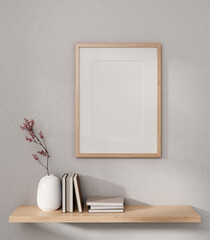 Front view of a picture frame mockup and a wooden wall shelf with home decor on a white wall.