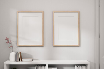 Two picture frames mockup on a white wall and a white bookcase in a white minimal room.