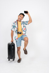 A man in summer clothes is feeling excited to travel and enjoy his summer vacation at the beach.