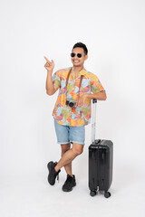 A fun, cheerful Asian man tourist is pointing his finger up at an empty space, isolated background