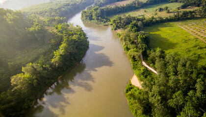 Fototapeta na wymiar Aerial shot of tranquil morning river amid untouched nature