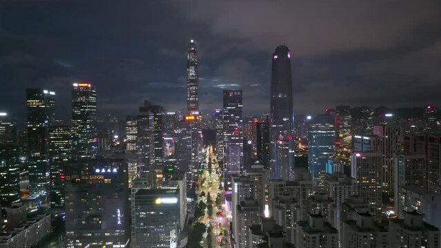 Drone fly over Shenzhen city central business district, aerial panorama China at night.