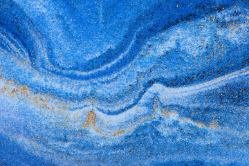 Abstract closeup dust of pigment sparkling with blue color background