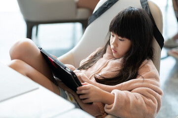 Kid watching tablet on the food table, children addicted cartoon