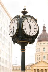 Fototapeta na wymiar Topeka, Kansas, USA - June 17, 2023: Afternoon light shines on a historic clock tower in downtown Topeka.