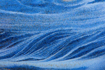 Closeup dust of pigment sparkling with blue color，Abstract mountain background