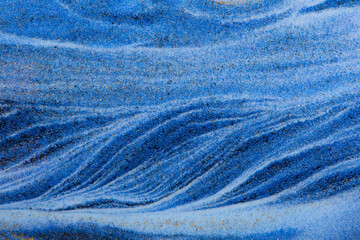 Closeup dust of pigment sparkling with blue color，Abstract mountain background