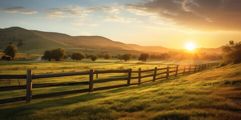 Obraz premium Landscape featuring a fenced ranch at sunrise with sunlights shimmering and creating a defocused effect