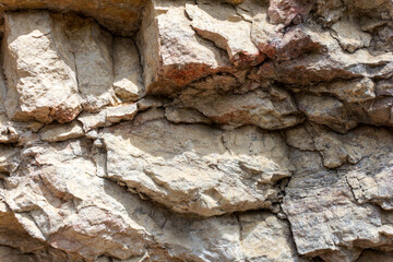 the wall of a mountain canyon made of natural material, stone - limestone material of volcanic...