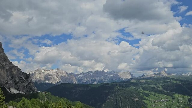 Timelapse video of valley in Italian Dolomites. Sunny day with clouds passing by.
