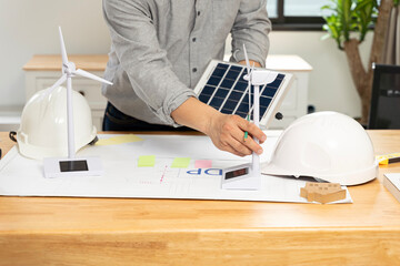 Desk of architects Solar Energy Powered Home Green for reduce global warming concept.