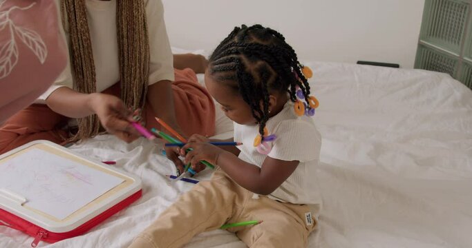cute little adorable girl holding colorful pencils, playing, choosing them to color, entertainment, Montessori method of teaching kids. development of children slow motion