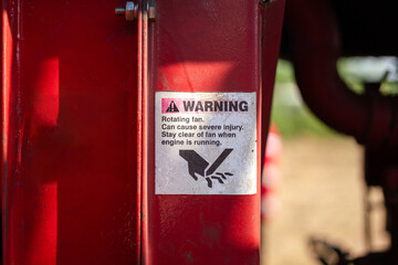 The caution sign to inform pinch point and hand injury hazard which is displayed on the machinery...