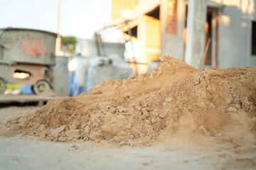 Pile of fine sand for building the house that stack on the ground with construction site as blurred...
