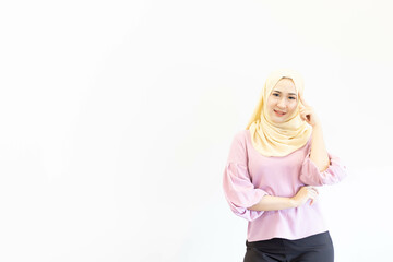 Cheerful Asian Muslim woman doing various poses in the free space and white background