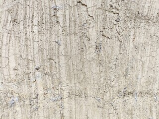 Dry cracked plaster texture with vertical striations and random crack patterns