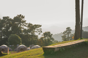 landscape and travel concept with wooden on floor with cloudy sky with camping tent on mountain