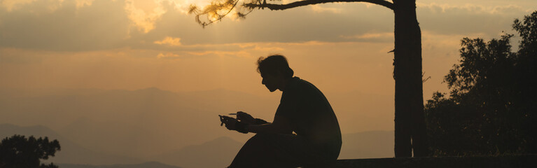 landscape and travel concept with solo freelancer man work and see sunset and twilight sky with layer of mountain