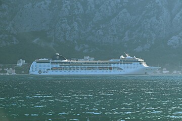 A cruise ship in the morning haze in the Bay of Kotor at the roadstead of the port of the city of...