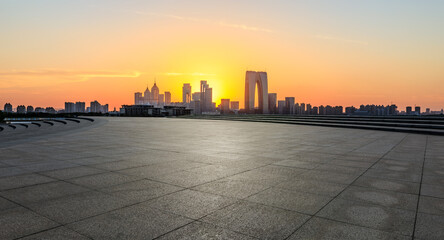 Fototapeta na wymiar City square and skyline with modern buildings at sunset in Suzhou, China. Panoramic view.