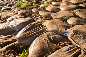 Aged sandbags on the ground