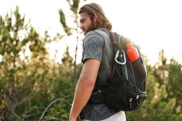 Portrait of hiker man with backpack trekking in the mountains