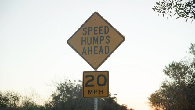 Speed humps bumps ahead street sign to make cars drive slower at 20mph