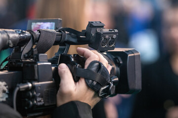 Media camera stands poised, capturing the dynamic energy and captivating details of an event.