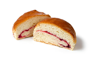 Round bread with jam cut in half. A bun on a white background. Two halves of a sweet bun.