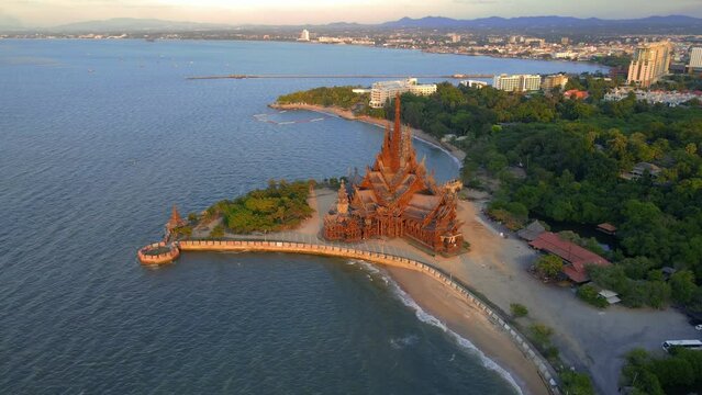 Sunset at the Sanctuary of Truth wooden temple in Pattaya Thailand. 