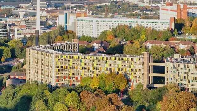 Colorful windows at a highrise apartement complex in Sheffield during sunrise. Drone shot