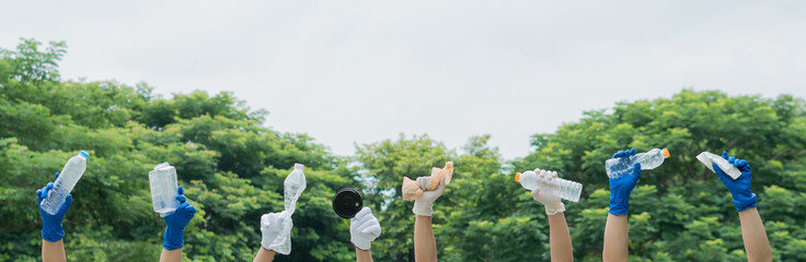 volunteer group raising hands. with plastic bottle and garbage.Ecology concept.Social...