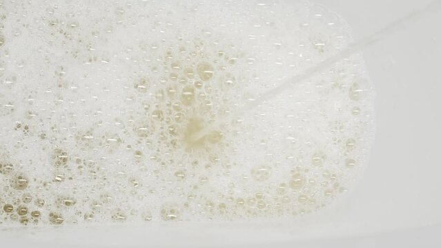 A stream of urine in a white toilet