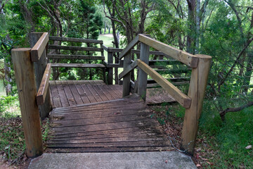 Entrance to weathered wooden stairs leading down a steep slope to the Coochiemudlo Island golf course.