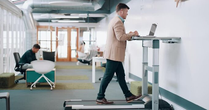 Working, businessman or walking on treadmill in office, listening to music in fitness workout. Training, exercise or busy worker typing on laptop in modern workplace or startup for streaming podcast