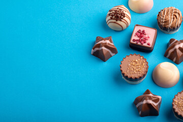 photo, a set of assorted chocolates forms a tempting array of sweet delights. Each piece, with its...
