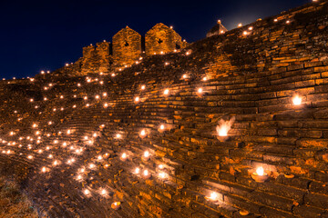 Fire a candle on the old wall is Lanna Candle Trays Around Chiang Mai moat in Loy Krathong (Yi peng) Festival Chiang Mai Thailand,many candles Light background