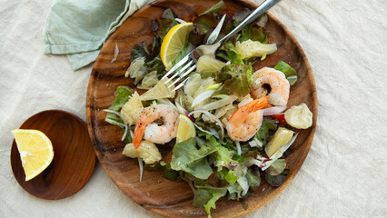 plate with salad with shrimp and pomelo on the table