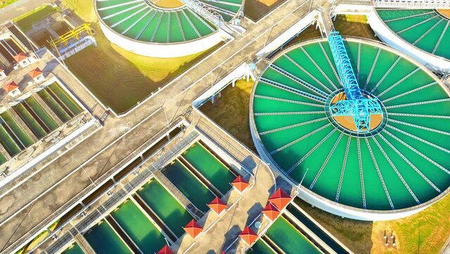A wastewater treatment plant purifies contaminated water, ensuring it meets rigorous standards for safe, clean drinking water. Infrastructure and water management concept. Aerial view drone.
