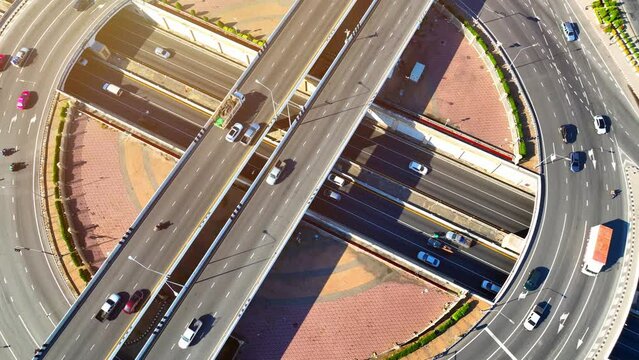 Captured from above, the interchange roundabout with tunnel is the urban heartbeat, a complex web of roads and passages that keeps the city connected and alive. Urban and vehicle concept. 4K HDR.
