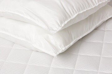 Soft comfortable white pillows on a bed
