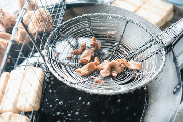 Making fried entrails of pig in hot oil, Phuket traditional food is called Loba. Loba is deep fried...