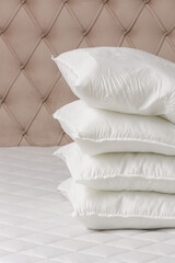 Soft comfortable white pillows on a bed
