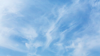 Whispy beautiful clouds at blue sky. Bright summer day. Atmosphere sky background