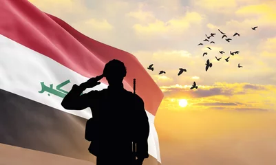 Foto op Plexiglas Silhouette of a soldier with the Iraq flag stands against the background of a sunset or sunrise. Concept of national holidays. Commemoration Day. ©  minionionniloy