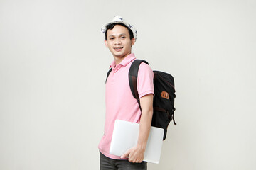 Asian man backpacker holding laptop computer. digital nomad and travelling concept. on isolated background