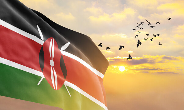Waving flag of Kenya against the background of a sunset or sunrise. Kenya flag for Independence Day. The symbol of the state on wavy fabric.